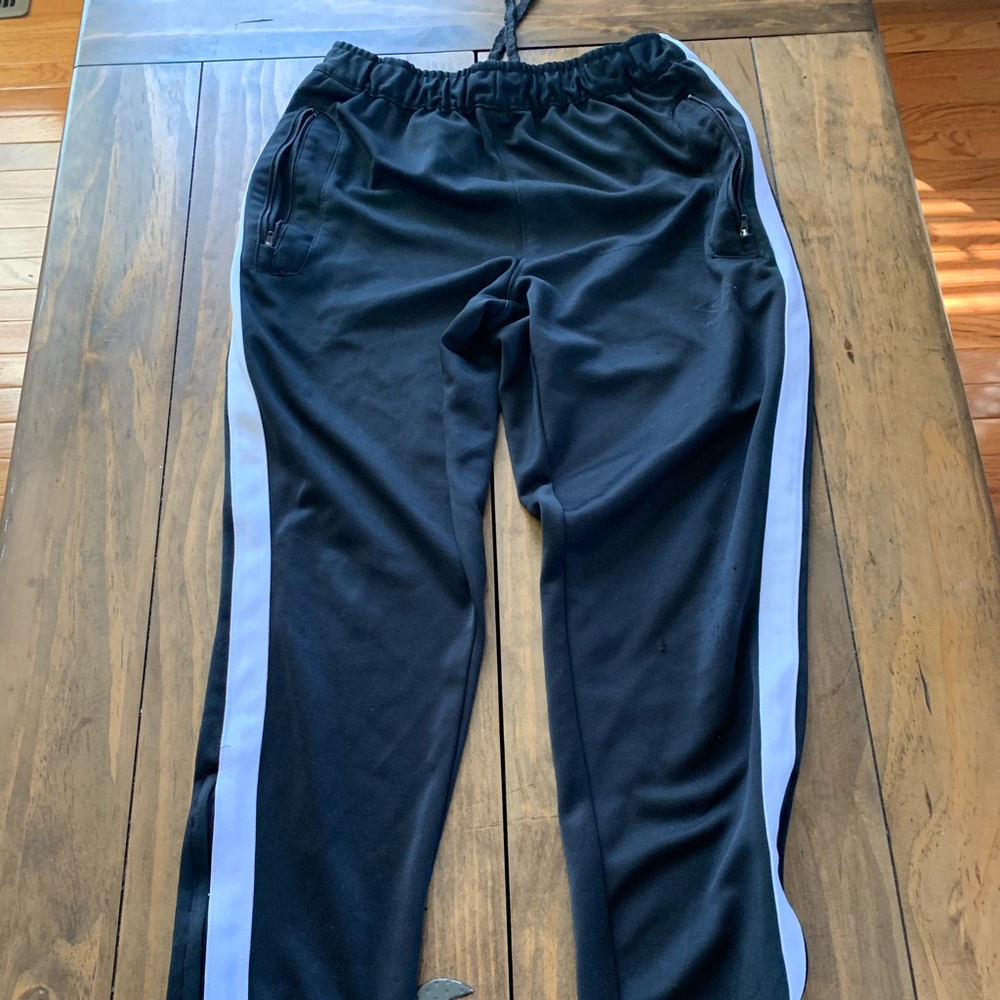 Black Umbro poly soccer pants. men’s SM. Zip leg